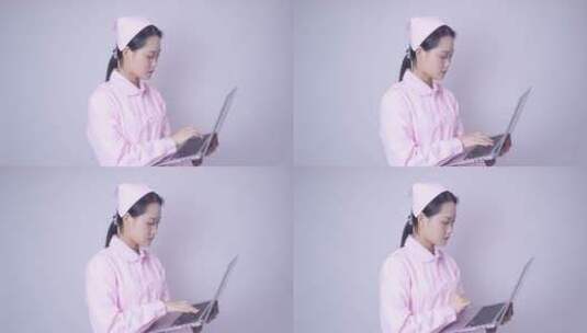年轻女性医护形象手持笔记本电脑办公高清在线视频素材下载
