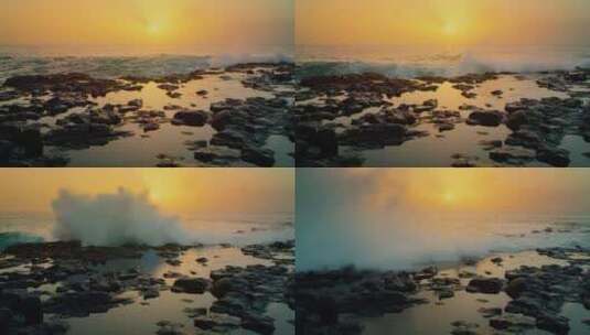 夕阳背景下海浪拍打礁石高清在线视频素材下载