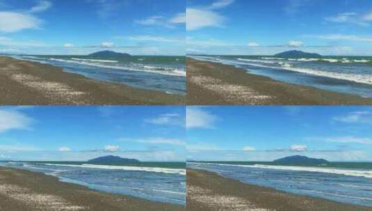 在美丽的晴天，新西兰Otaki海滩向Kapiti海滩缓慢变焦高清在线视频素材下载