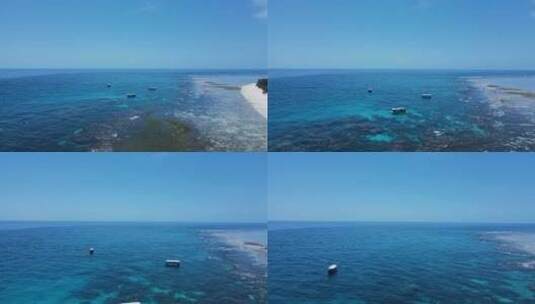 穿过大堡礁，看着停泊在热带岛屿蓝色水域中的水肺潜水船高清在线视频素材下载