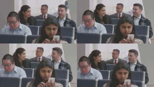 一男一女在机场坐在乘客旁边聊天高清在线视频素材下载