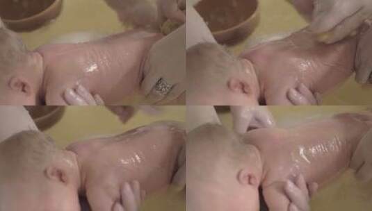 母亲给新生儿洗澡高清在线视频素材下载
