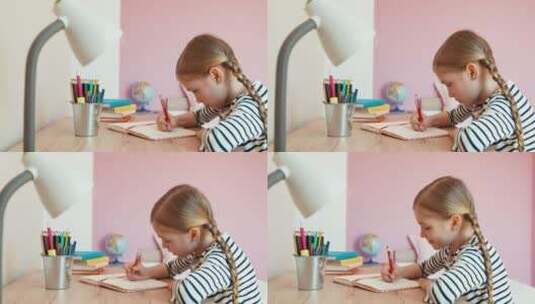 女孩坐在书桌前写作业高清在线视频素材下载