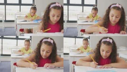 专注于不同女孩坐在学校课桌前学习的视频高清在线视频素材下载