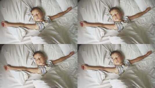 小男孩躺在床上睡觉高清在线视频素材下载