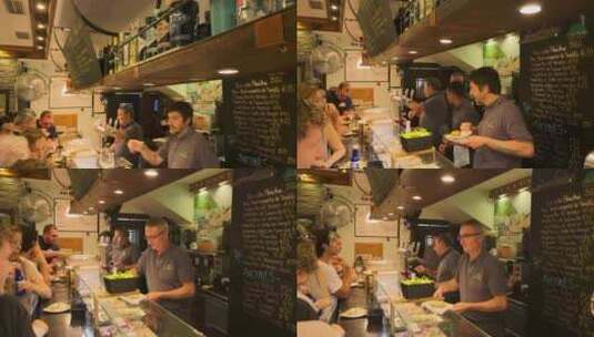 热闹的小吃店里吃tapas的食客高清在线视频素材下载