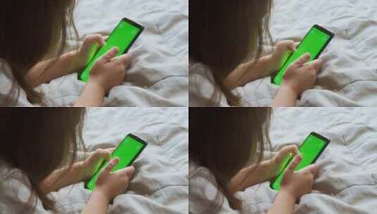 学龄前女孩使用绿屏智能手机高清在线视频素材下载