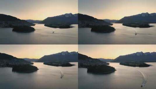 新西兰皇后镇瓦卡蒂普湖航拍朝霞小船高清在线视频素材下载