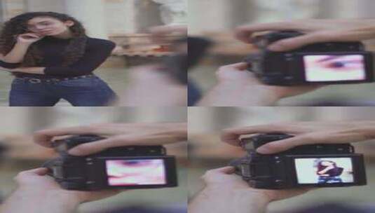 一名男性摄影师手持相机屏幕拍摄一名年轻的高清在线视频素材下载