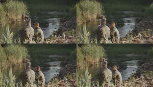 坐在河边吃饭的两个人高清在线视频素材下载