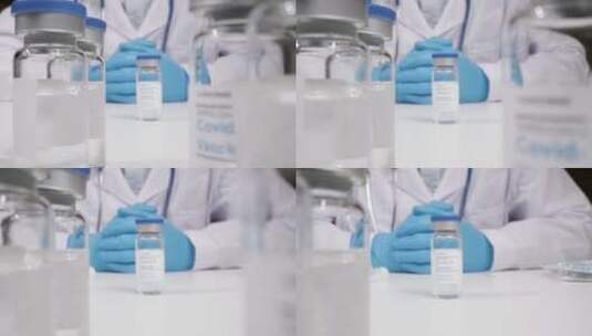 医疗专业人员拿起疫苗小瓶高清在线视频素材下载