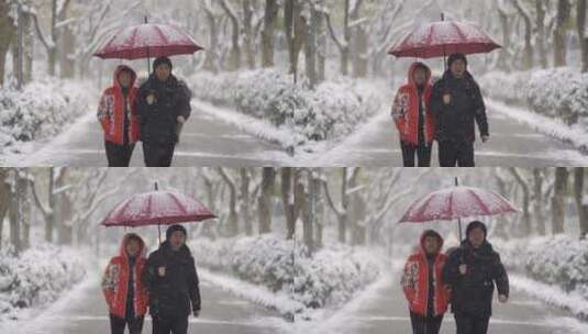 雪地里夫妻打伞有说有笑的走路高清在线视频素材下载