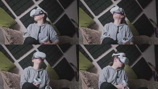 年轻女子坐在沙发上在家使用VR头盔玩游戏高清在线视频素材下载