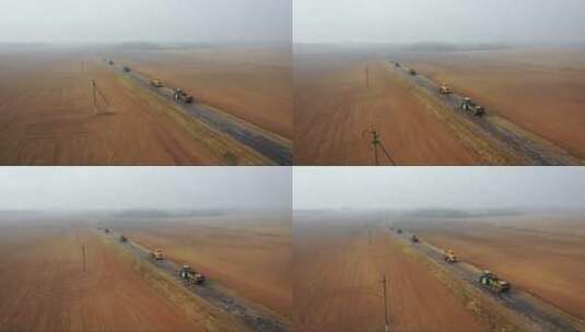 农场机械行驶在通往农田的道路上种植作物高清在线视频素材下载