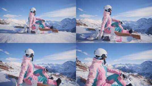 穿着滑雪服的女人坐在山顶高清在线视频素材下载