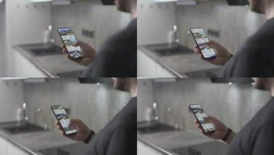 一个男人通过智能手机上的应用程序为自己选择了一个新家高清在线视频素材下载