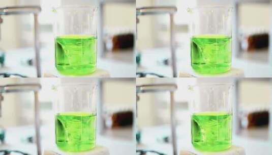 化学实验、绿色搅拌混合液体高清在线视频素材下载