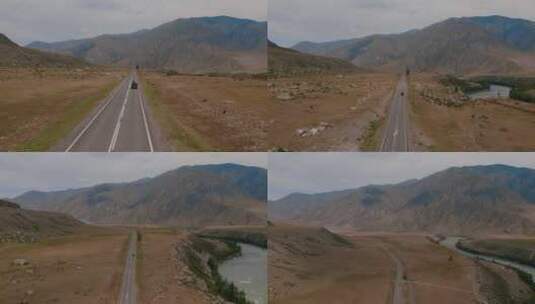 阿尔泰山脉山谷，在戏剧性的天空下，楚亚高速公路上有交通车辆高清在线视频素材下载