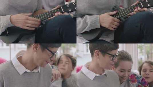 妈妈和她的孩子玩四弦琴高清在线视频素材下载