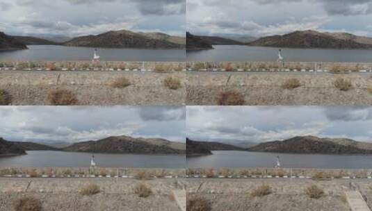 在湖坝上行走的女人高清在线视频素材下载