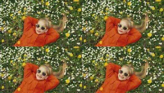 女孩躺在花丛里竖起大拇指高清在线视频素材下载