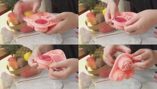 冰盒冰格拆出粉红色玫瑰冰块高清在线视频素材下载