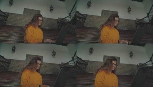 女人坐在楼梯上玩电脑高清在线视频素材下载