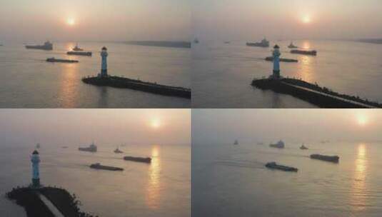 清晨日出唯美逆光灯塔下行驶的货船高清在线视频素材下载