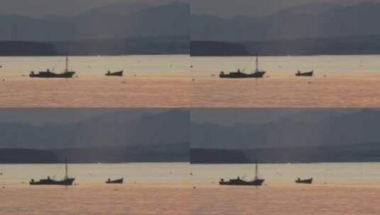 夕阳海面上的渔船和远处的山影高清在线视频素材下载