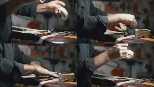 Luthier在他的店里打磨品之前用遮蔽胶带覆盖吉他体高清在线视频素材下载