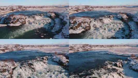 在冬雪期间用无人机拍摄冰岛美丽的瀑布和河高清在线视频素材下载