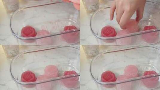 冰盒冰格拆出粉红色玫瑰冰块高清在线视频素材下载