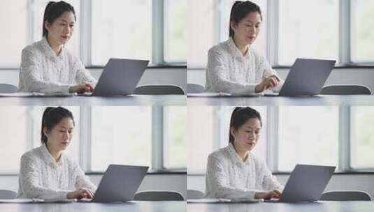 职业女性在办公室用笔记本电脑工作高清在线视频素材下载