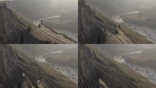 人站在安集海大峡谷的悬崖峭壁之上高清在线视频素材下载
