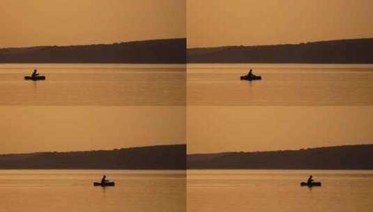 船上渔夫的剪影。日落时从船上在湖上钓鱼高清在线视频素材下载