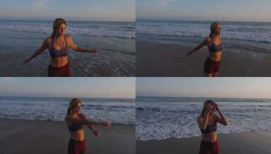 迷人的女人在海滩上锻炼高清在线视频素材下载