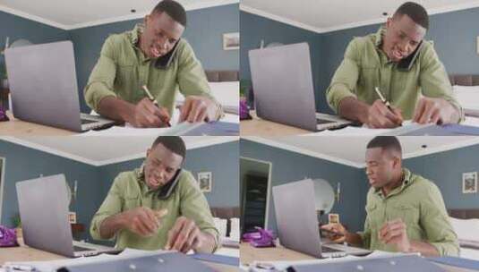 非裔美国男子使用笔记本电脑、说话智能手机和写笔记的视频，在卧室工作高清在线视频素材下载