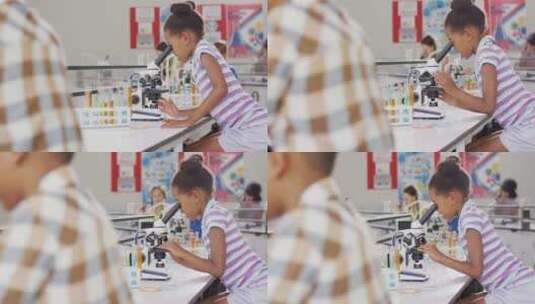 女孩在上课时用显微镜高清在线视频素材下载
