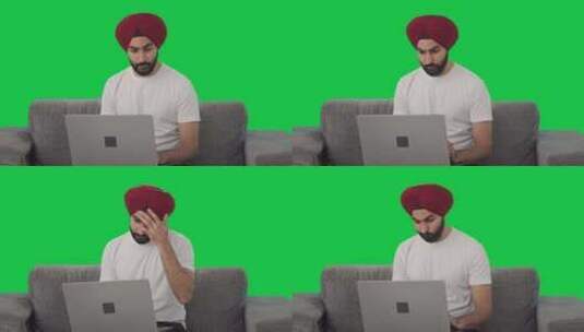 困惑的锡克教印度人使用笔记本电脑绿屏高清在线视频素材下载