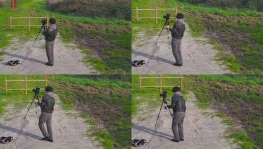 男子在户外三脚架上设置相机-无人机射击高清在线视频素材下载