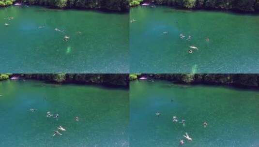 俯瞰水母湖，人们在里面游泳。密克罗尼西亚高清在线视频素材下载