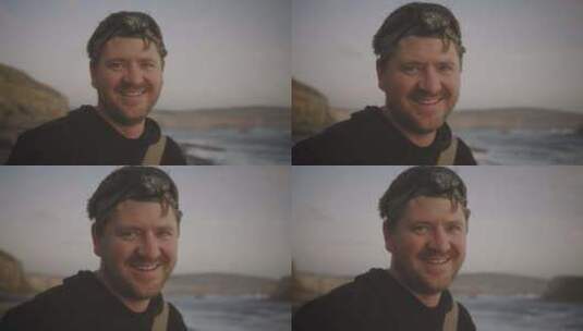 一名海上男子戴着露营头手电筒，微笑着直视高清在线视频素材下载
