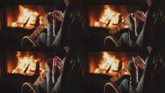 女人坐在壁炉旁织毛衣高清在线视频素材下载