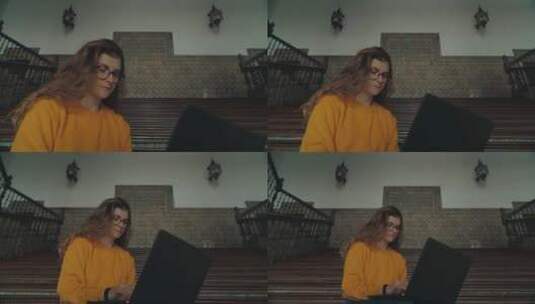 女孩在楼梯上用笔记本学习高清在线视频素材下载