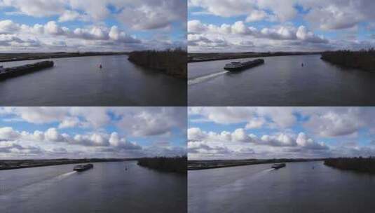 荷兰南荷兰乌德马斯河白天反冲洗驳船的鸟瞰图。高清在线视频素材下载