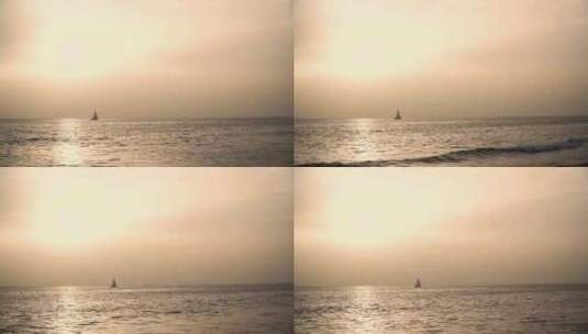 特写日落下海平面上漂流的帆船高清在线视频素材下载