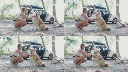 快乐的女人和她可爱的狗在大自然中度过时光高清在线视频素材下载