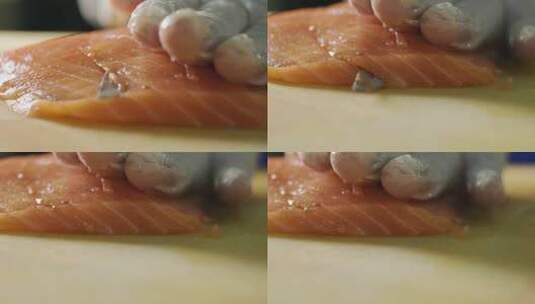 厨师用鱼片刀切新鲜橙色鱼肉的特写镜头高清在线视频素材下载