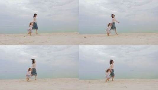 妈妈牵着女儿在沙滩上奔跑高清在线视频素材下载