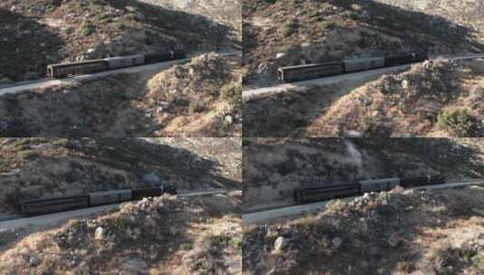 航拍火车在山间铁路上行驶高清在线视频素材下载